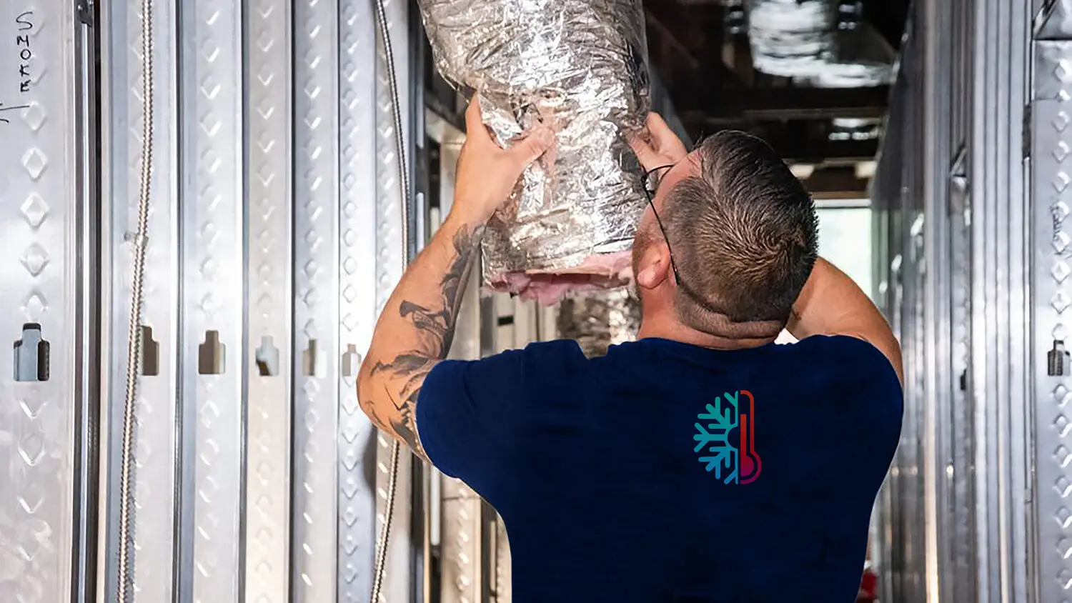 Besson Employee working on a duct